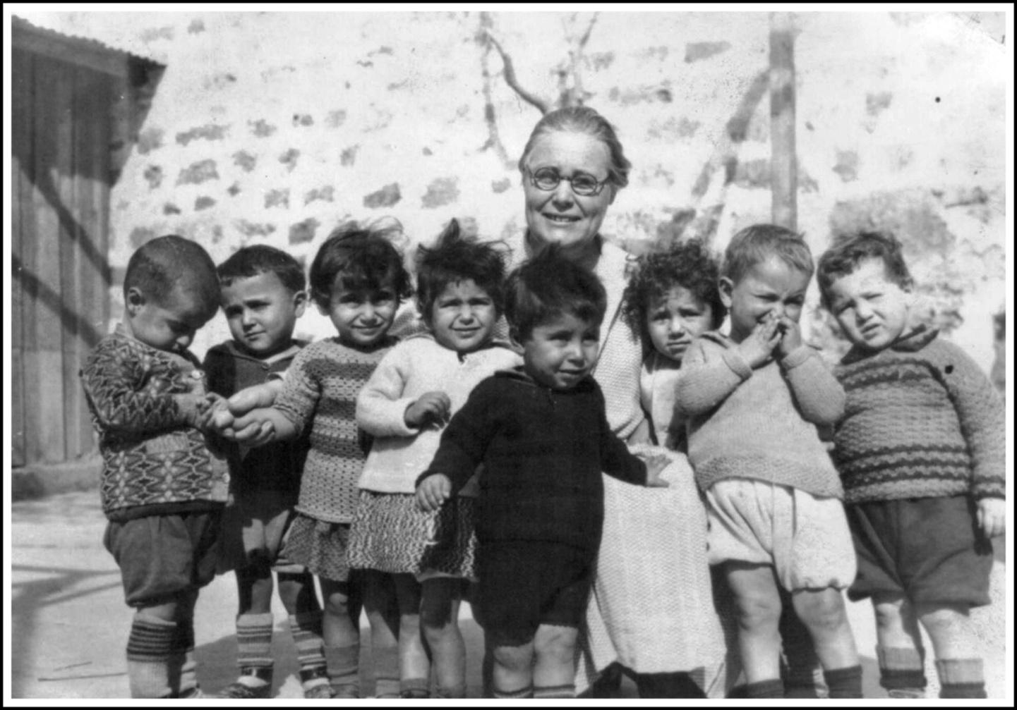 A person with a group of children
Description automatically generated with medium confidence